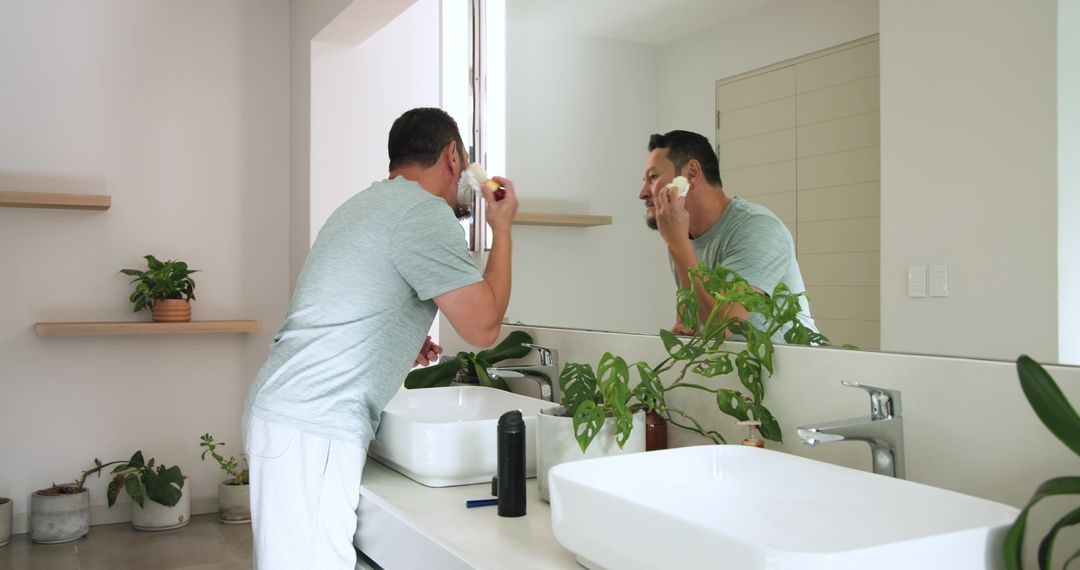 Man Applying Shaving Cream in Modern Minimalist Bathroom