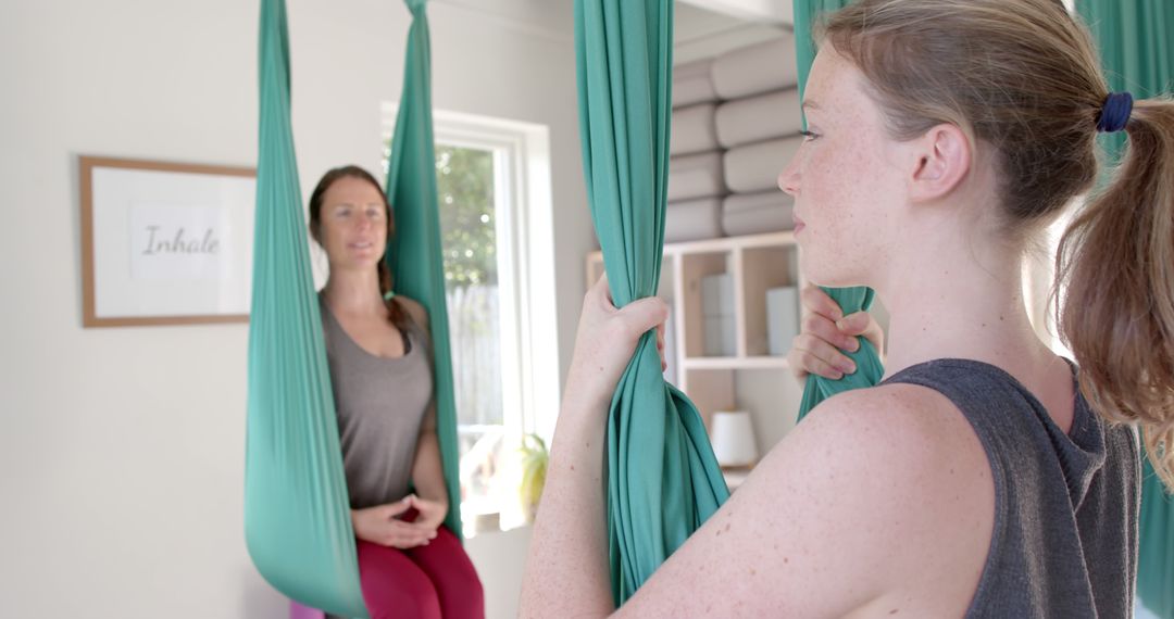 Women Practicing Aerial Yoga Together in Bright Studio - Free Images, Stock Photos and Pictures on Pikwizard.com