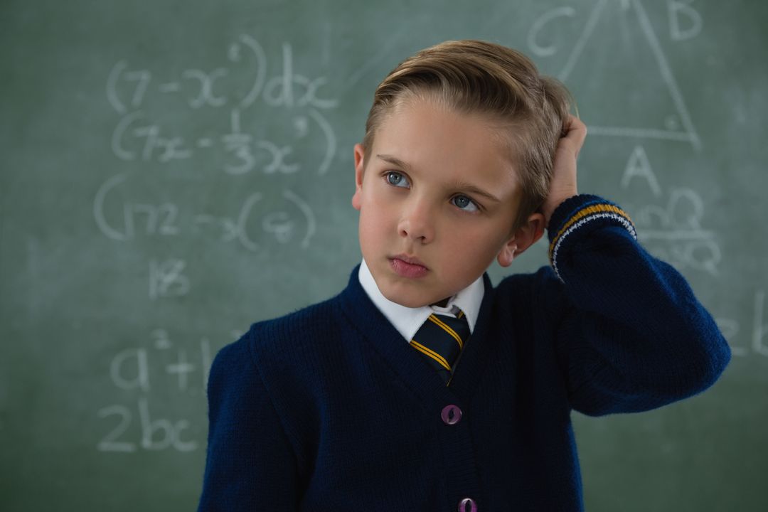 Schoolboy standing against chalkboard - Free Images, Stock Photos and Pictures on Pikwizard.com
