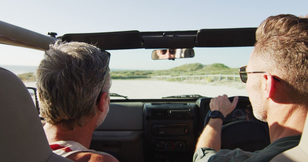 Two Men Driving Convertible on Coastal Road - Free Images, Stock Photos and Pictures on Pikwizard.com