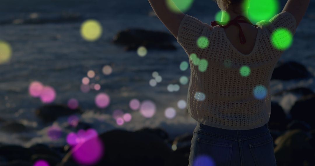 Woman Relaxing on Rocks with Colorful Light Reflection