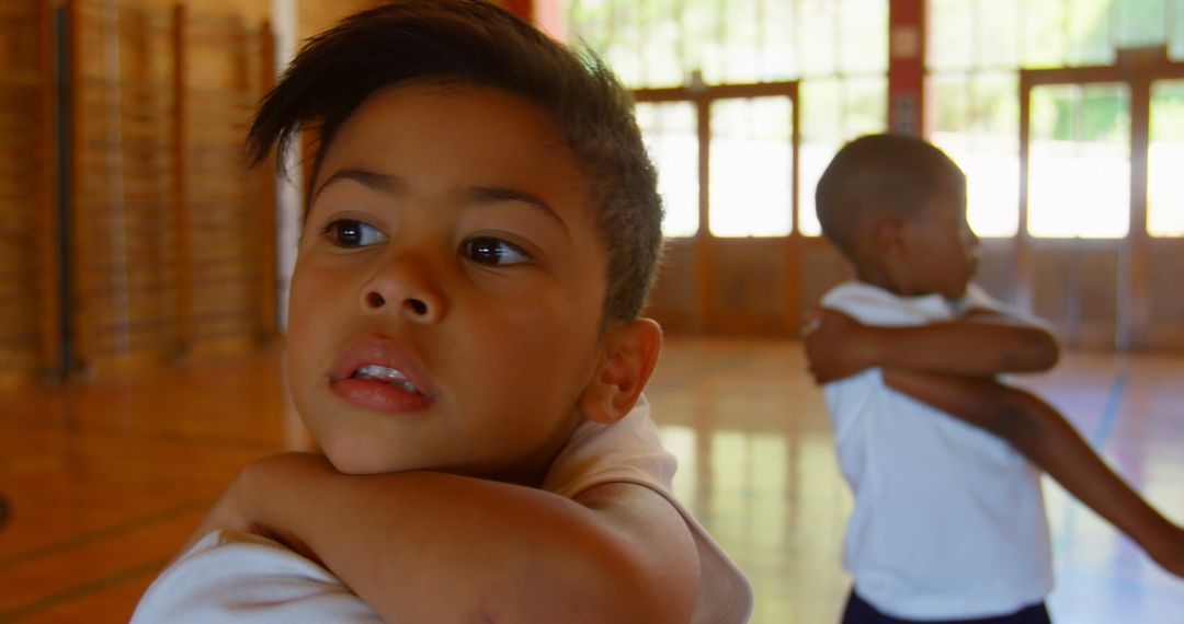 Diverse Schoolkids Practicing Yoga and Stretching in Gym