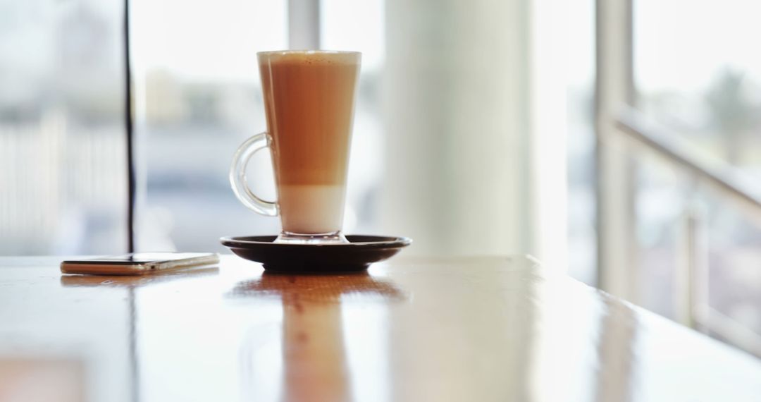 Hot Latte on Wooden Table in Sunlit Cafe - Free Images, Stock Photos and Pictures on Pikwizard.com