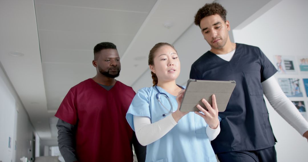 Diverse Healthcare Team Analyzing Data in Hospital Corridor
