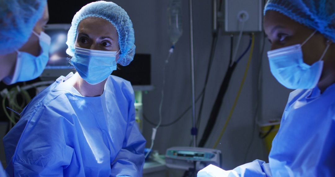 Diverse surgeons wearing surgical caps and face masks in operating theatre in hospital - Free Images, Stock Photos and Pictures on Pikwizard.com