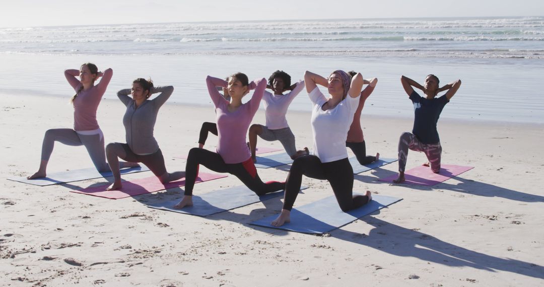 Group of Women Practicing Yoga on the Beach - Free Images, Stock Photos and Pictures on Pikwizard.com