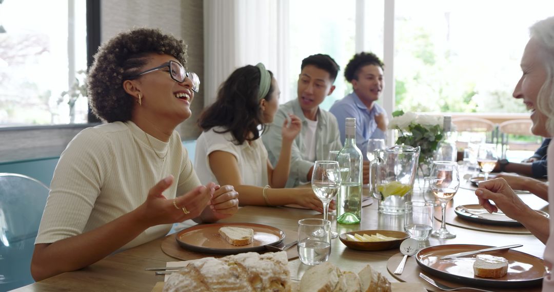 Friends Laughing Together at Elegant Dining Table Gathering
