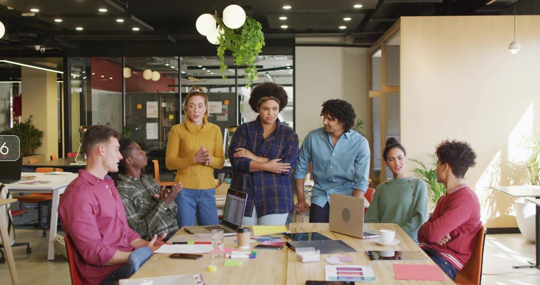 Diverse Team Collaborating Around Table in Modern Office Environment