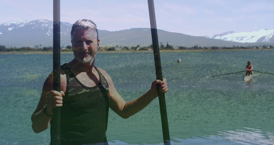 Man Paddleboarding on Lake with Mountains in Background - Free Images, Stock Photos and Pictures on Pikwizard.com