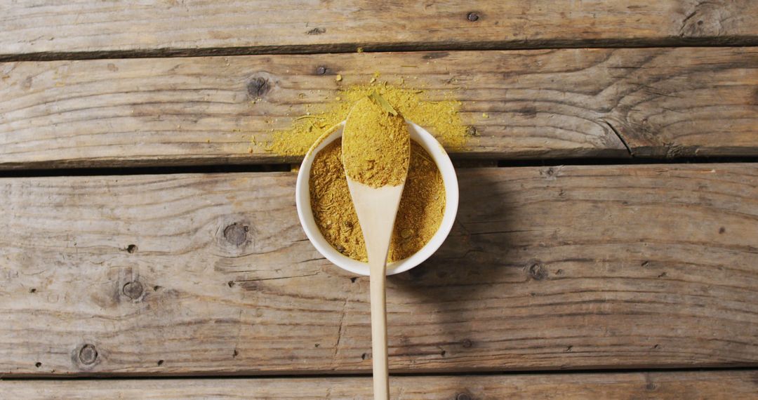 Turmeric Powder in Wooden Bowl on Rustic Table - Free Images, Stock Photos and Pictures on Pikwizard.com