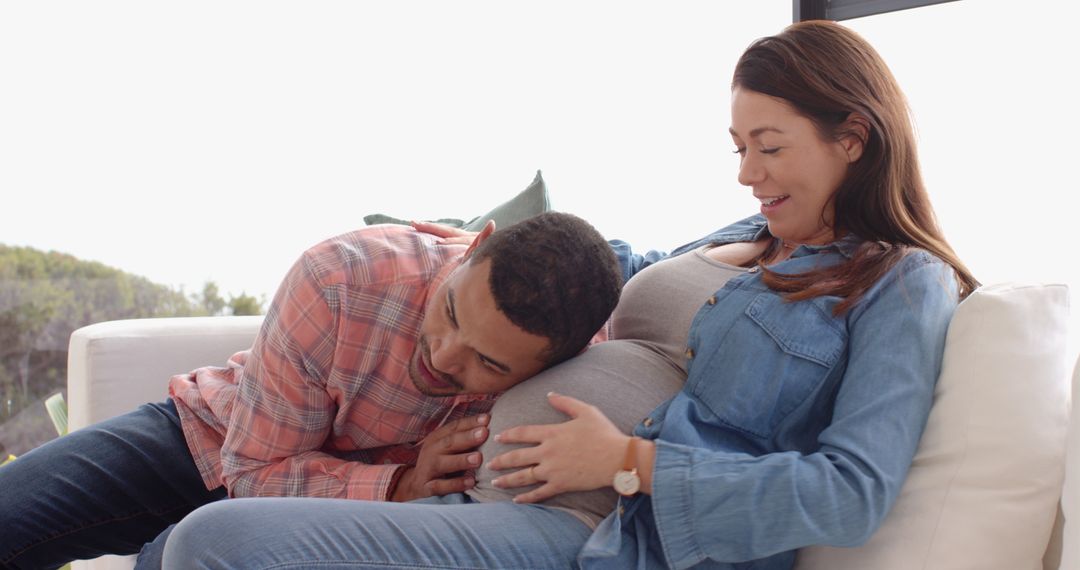 Couple Enjoying Precious Moments with Baby Bump at Home