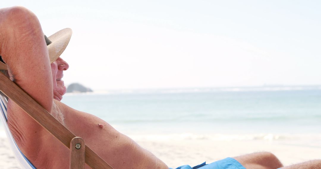 Elderly Man Relaxing in Deckchair on Beachfront