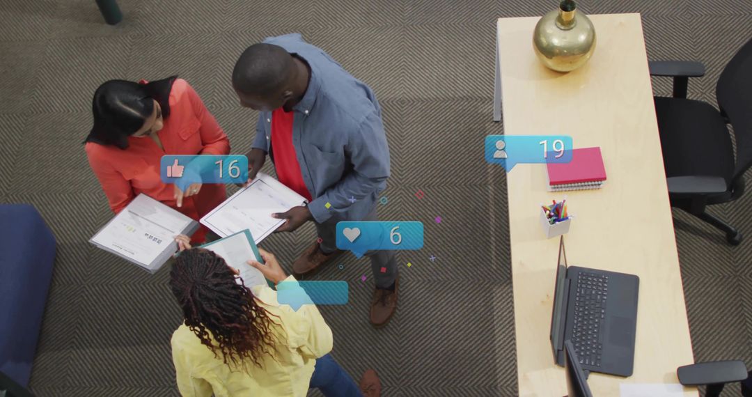 Team reviewing documents and collaborating in office with social media notifications