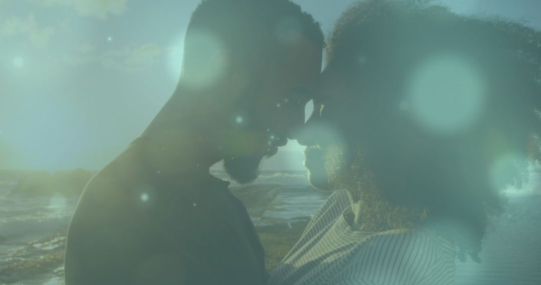 Romantic Couple Embracing on Beach with Dreamy Light Effects