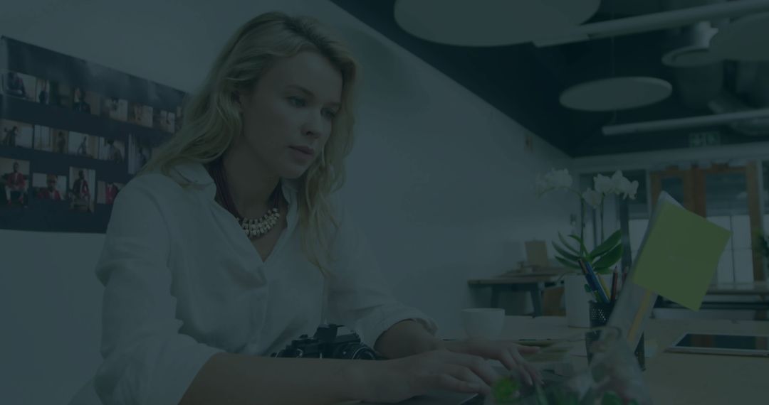 Woman Typing on Laptop in Modern Workspace