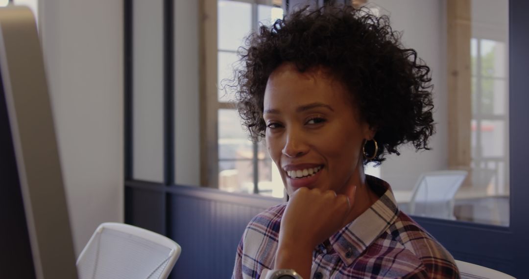 Cheerful Graphic Designer Working at Desk in Modern Office