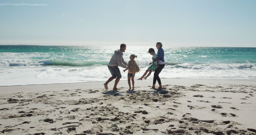 Family Enjoying Fun Day at the Beach with Clear Blue Waters - Free Images, Stock Photos and Pictures on Pikwizard.com