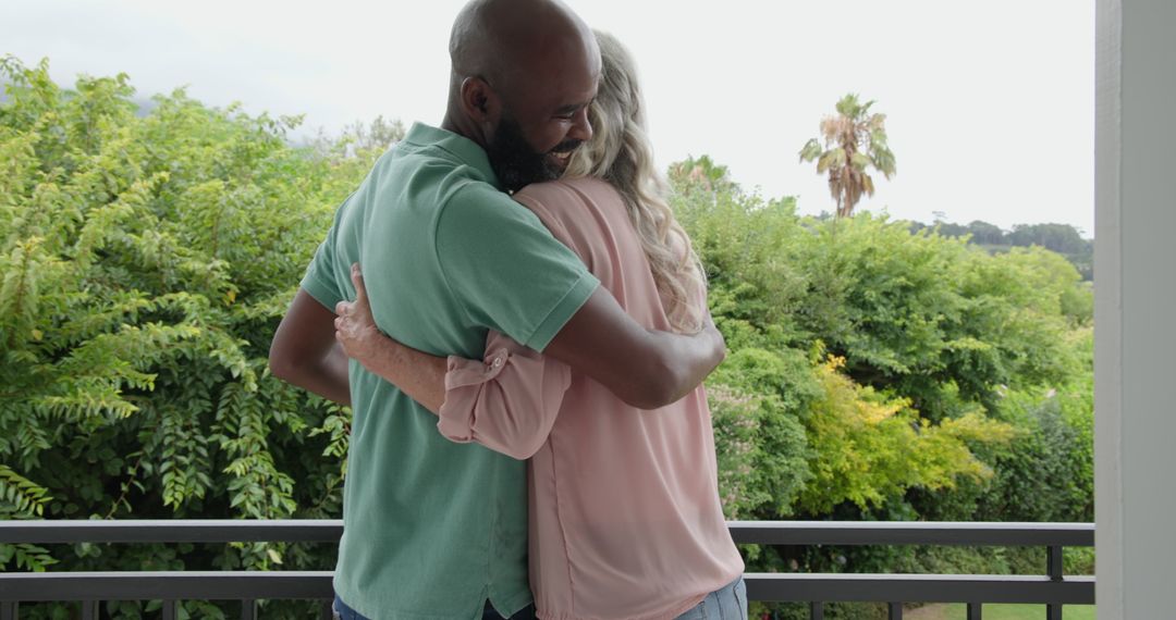 Romantic Embrace on Balcony in Scenic Setting