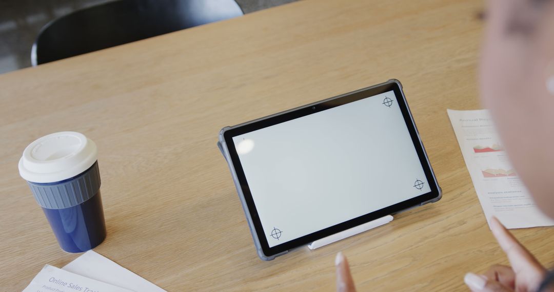 Tablet with blank screen on desk near takeaway coffee cup and documents - Free Images, Stock Photos and Pictures on Pikwizard.com