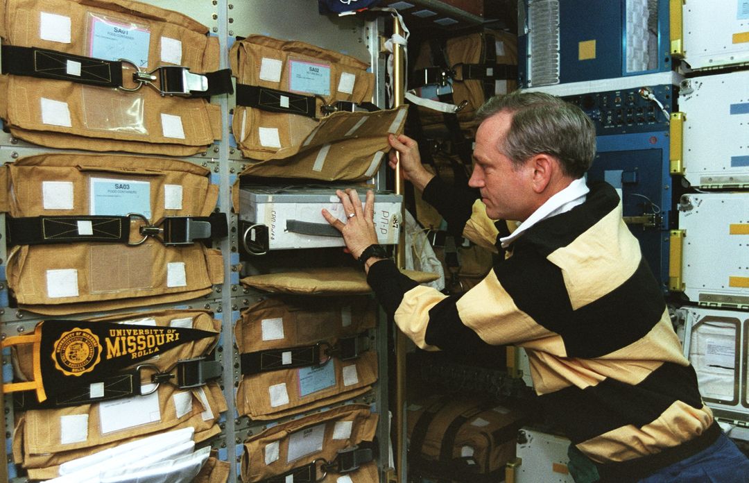 Astronaut Overseeing Storage in Spacehab Module on SS