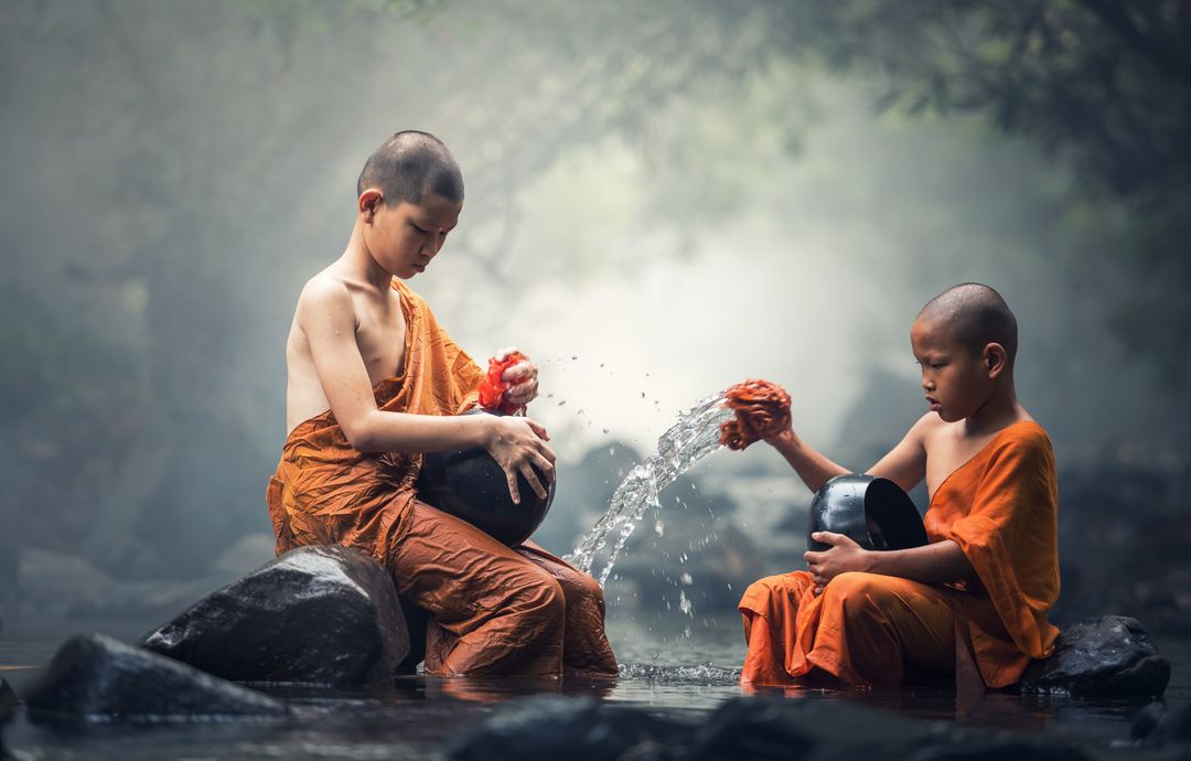 Young Buddhist Monks Washing Bowls in Misty Forest Stream - Free Images, Stock Photos and Pictures on Pikwizard.com