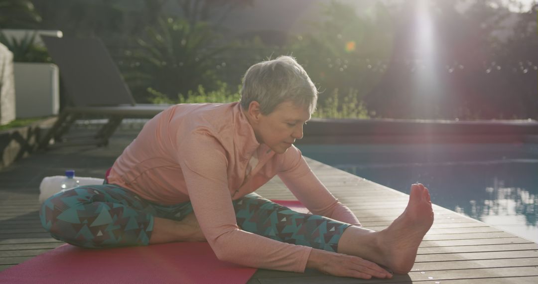 Senior Woman Practicing Yoga by Pool in Early Morning Light - Free Images, Stock Photos and Pictures on Pikwizard.com