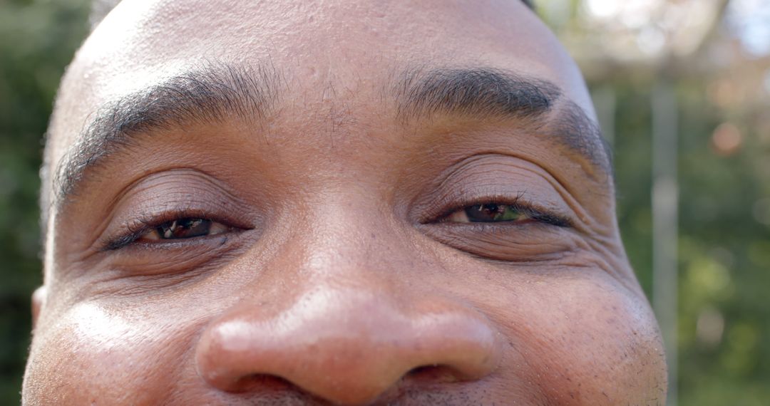 Close-up of Smiling Man's Eyes and Nose Outdoors - Free Images, Stock Photos and Pictures on Pikwizard.com