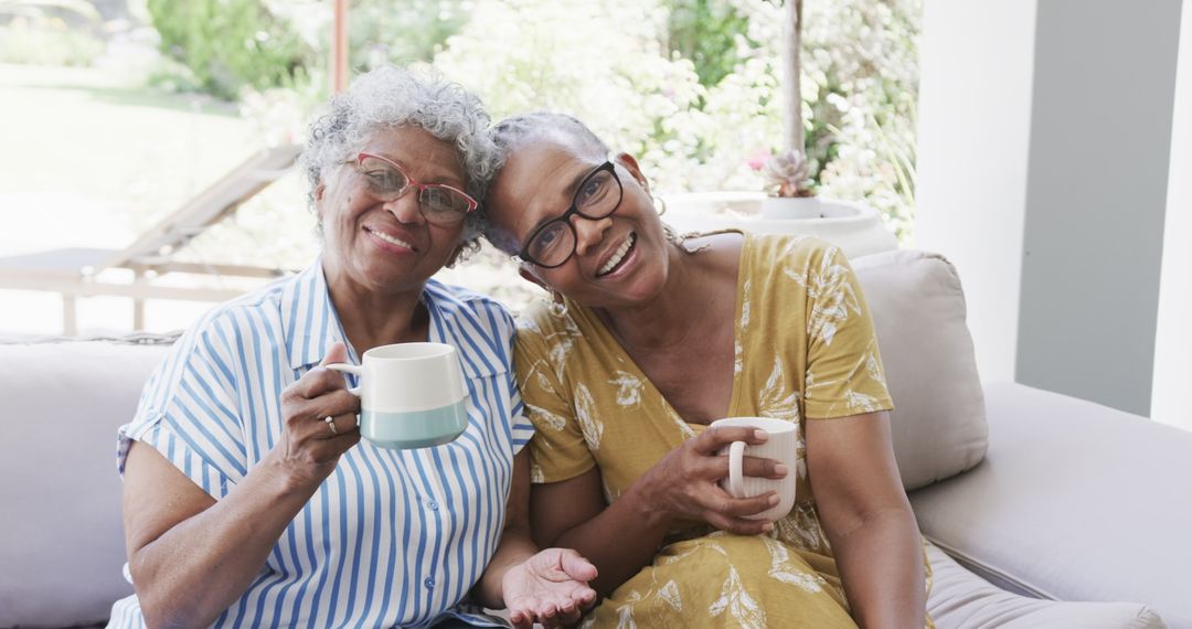 Senior women enjoying tea time at home together