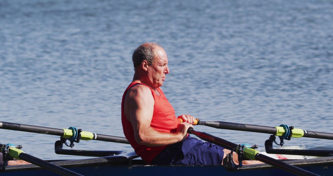 Senior Male Rowing in Blue Boat on Lake - Free Images, Stock Photos and Pictures on Pikwizard.com