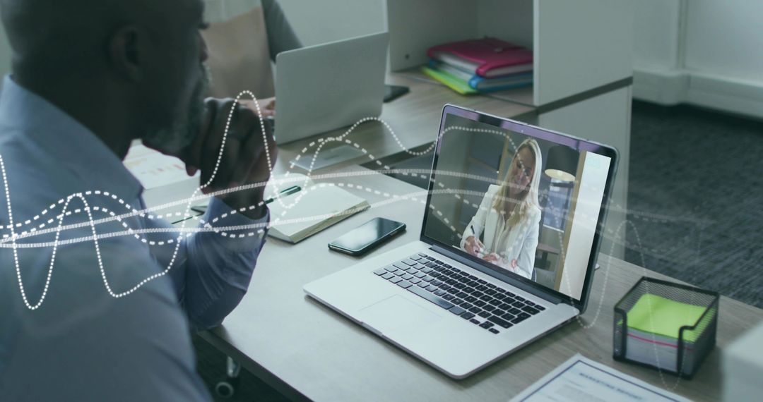 Businessman at Desk in Virtual Meeting with Digital Interface