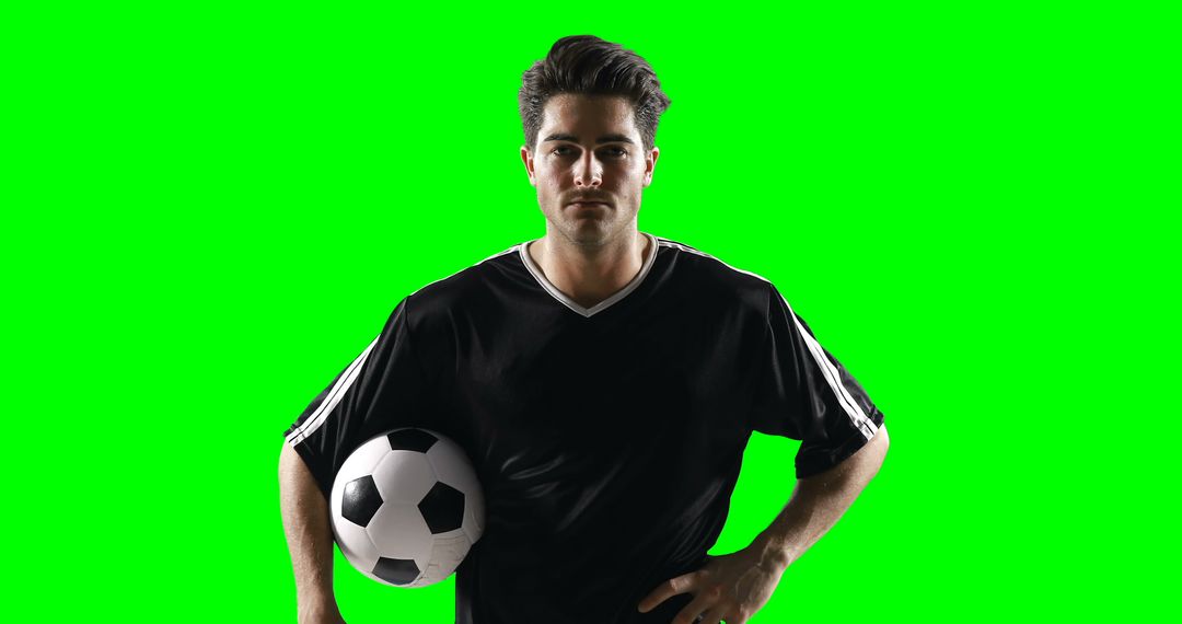 Portrait football player holding a football against green screen - Free Images, Stock Photos and Pictures on Pikwizard.com