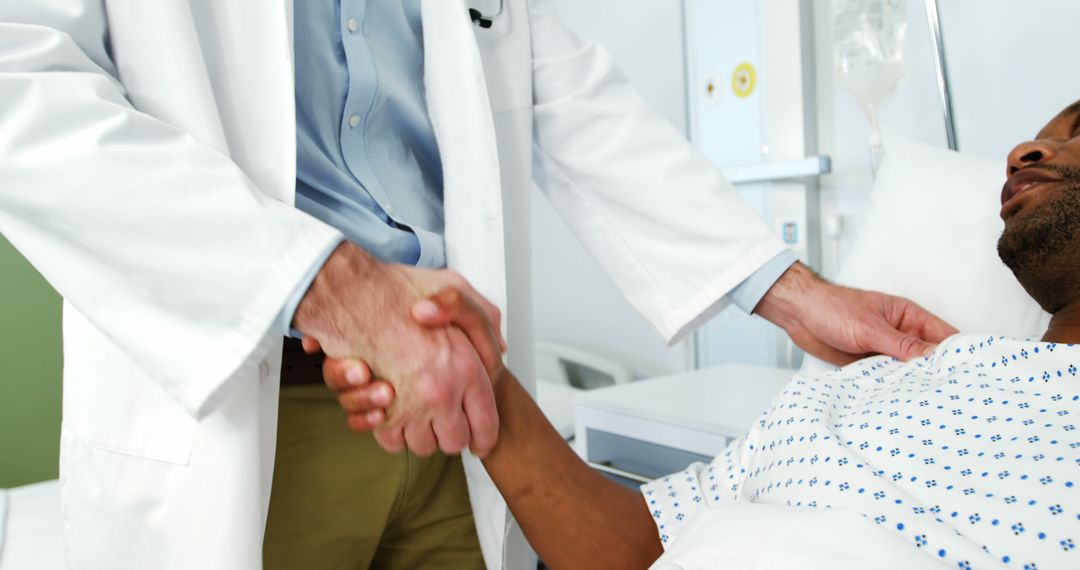 Doctor Shaking Hands with Recovering Patient in Hospital Bed - Free Images, Stock Photos and Pictures on Pikwizard.com