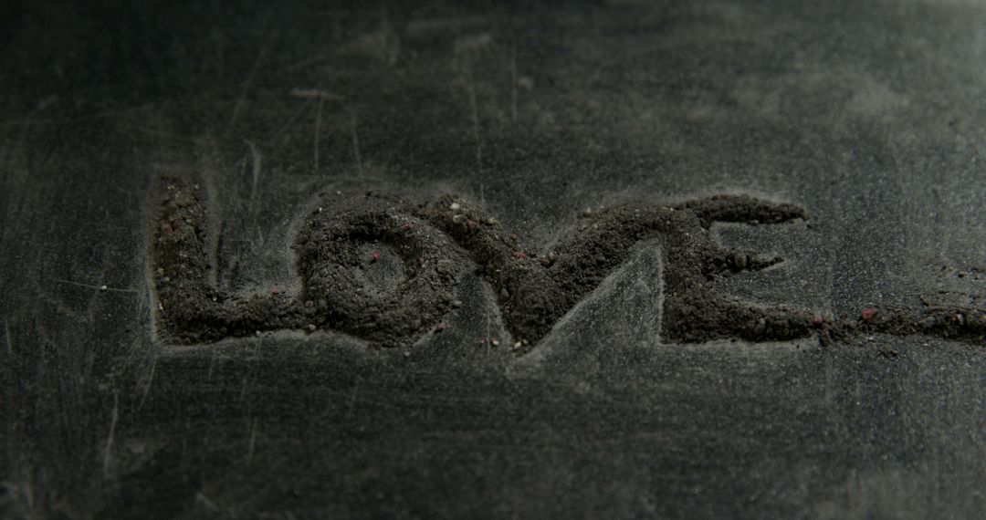 Word 'LOVE' is etched into a dark, textured surface, with copy space - Free Images, Stock Photos and Pictures on Pikwizard.com