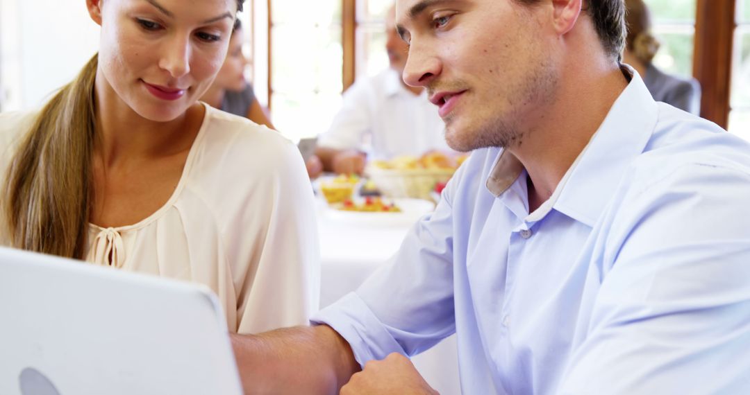 Couple using laptop in restaurant - Free Images, Stock Photos and Pictures on Pikwizard.com