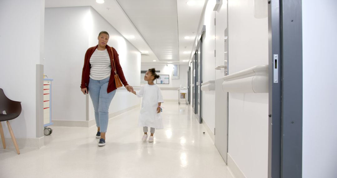 Mother and Child Walking in Hospital Corridor Holding Hands - Free Images, Stock Photos and Pictures on Pikwizard.com