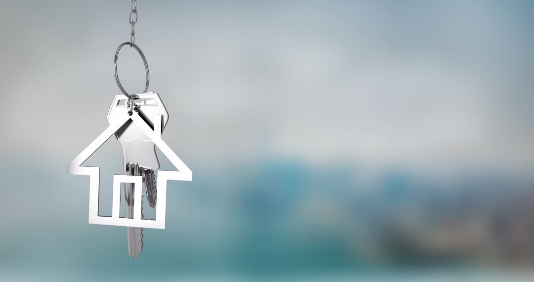 House Shaped Keychain with Keys Hanging Against Blurred Background