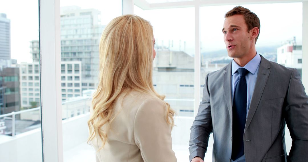 Two Business Professionals Handshaking in Modern Office - Free Images, Stock Photos and Pictures on Pikwizard.com