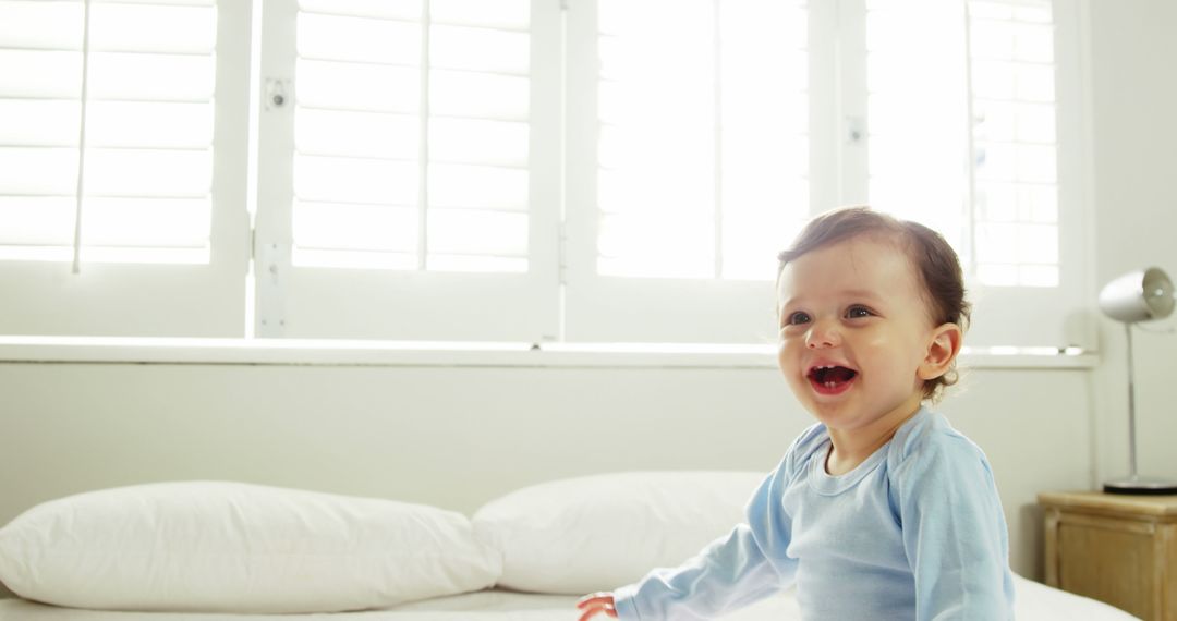 Cheerful Toddler Smiling in Bright Sunlit Room - Free Images, Stock Photos and Pictures on Pikwizard.com