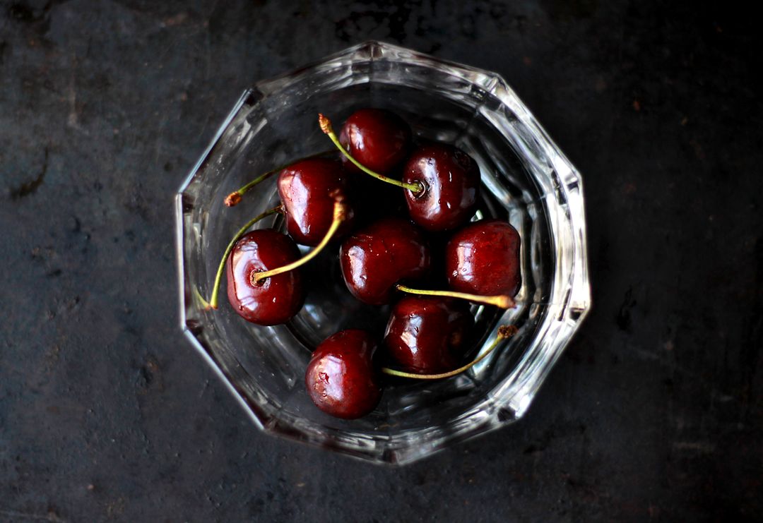 Fresh Dark Red Cherries in Glass Bowl on Dark Surface - Free Images, Stock Photos and Pictures on Pikwizard.com
