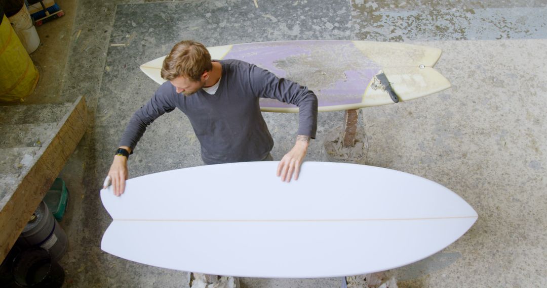 Craftsman Shaping Surfboard in Workshop Top View - Free Images, Stock Photos and Pictures on Pikwizard.com