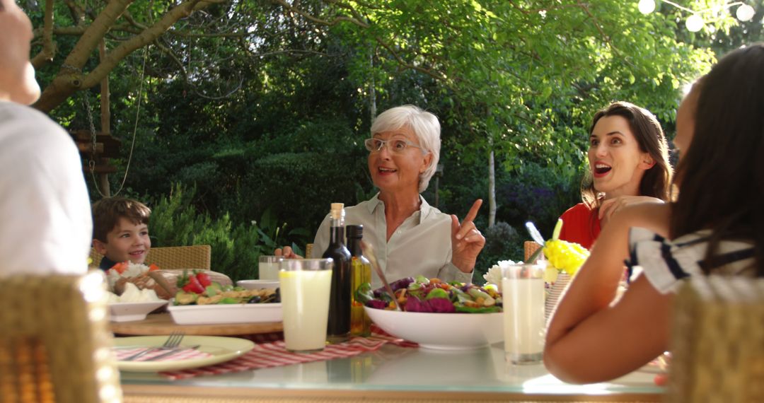 Family Enjoying Outdoor Meal in Garden - Free Images, Stock Photos and Pictures on Pikwizard.com