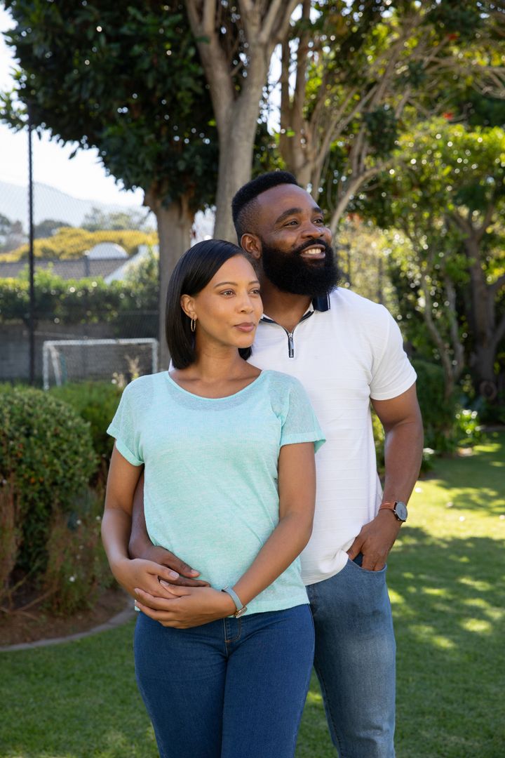Diverse Couple Enjoying Peaceful Moment in Lush Backyard Garden