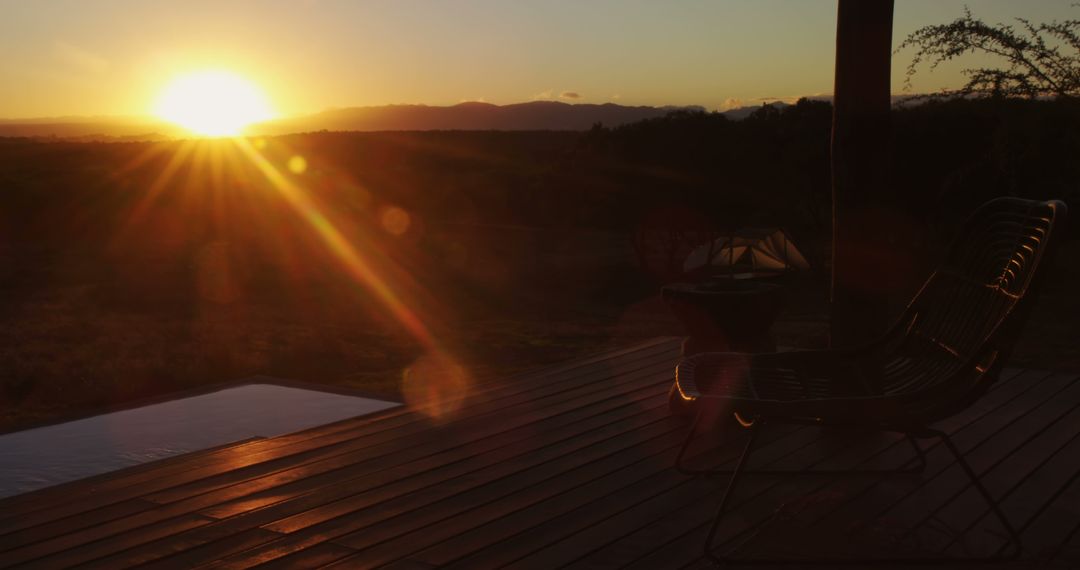 Sunset Over Tranquil Deck with Empty Chair - Free Images, Stock Photos and Pictures on Pikwizard.com