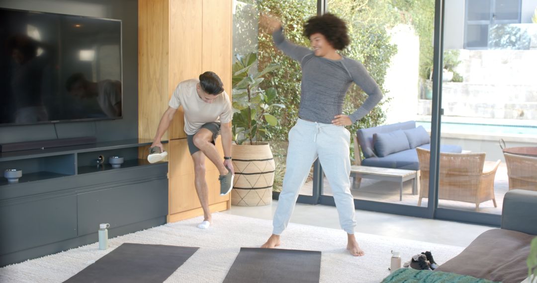 Two Men Warming Up for Exercise at Home in Modern Living Room