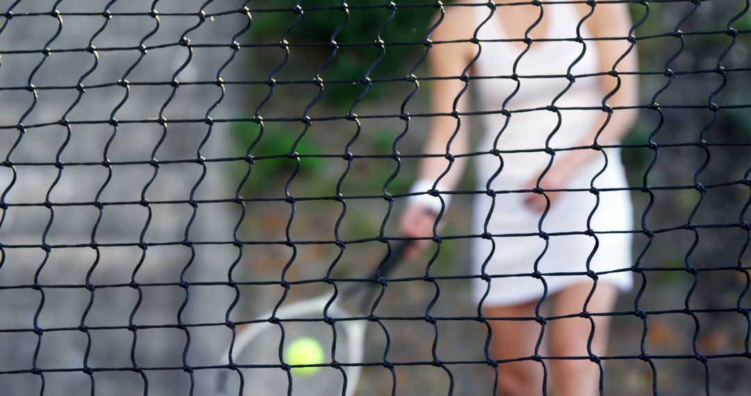 Tennis Player Preparing to Serve Behind Net - Free Images, Stock Photos and Pictures on Pikwizard.com