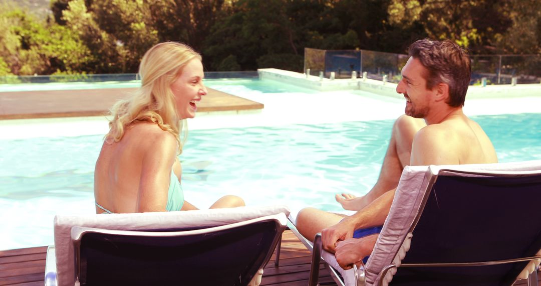 Happy Couple Laughing by the Poolside on a Sunny Day - Free Images, Stock Photos and Pictures on Pikwizard.com