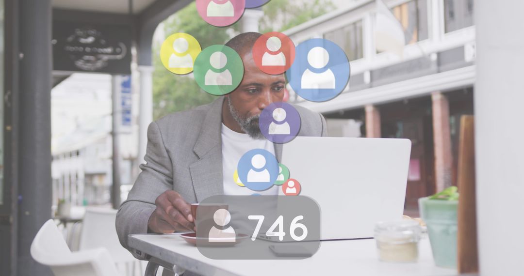 Man Connected to Global Social Network While Using Laptop at Café