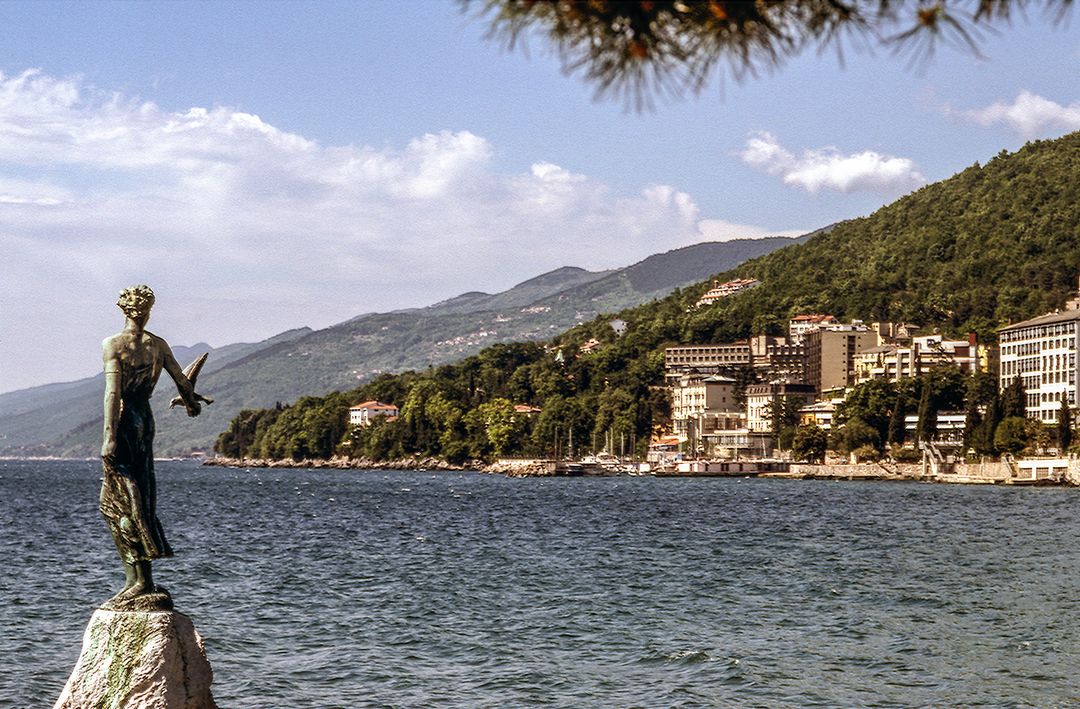 Seaside view of Opatija with bronze statue by the water - Free Images, Stock Photos and Pictures on Pikwizard.com