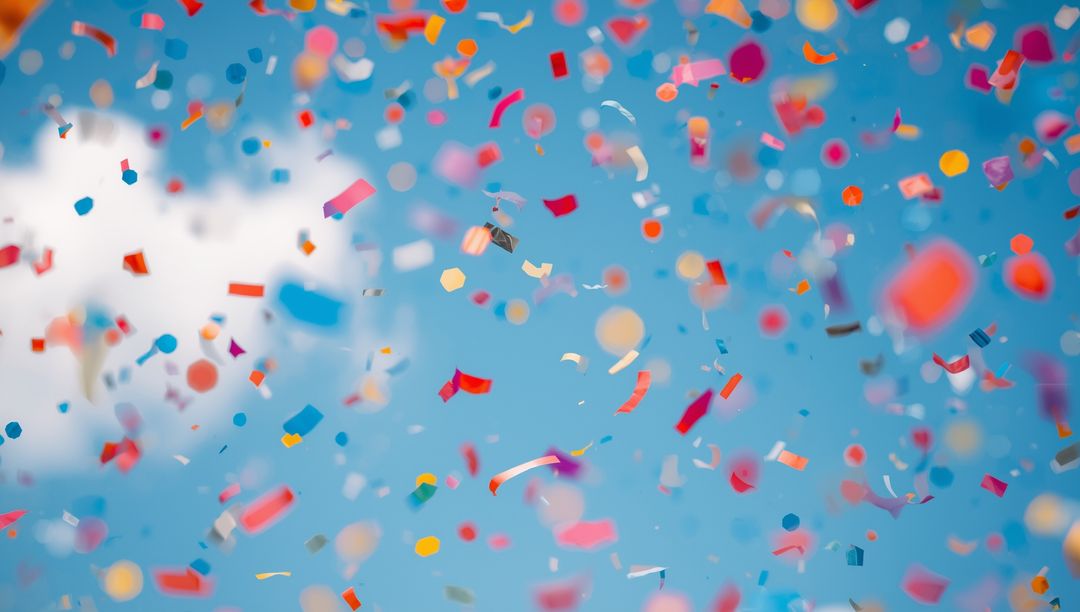 Vibrant Confetti Exploding Against Clear Blue Sky