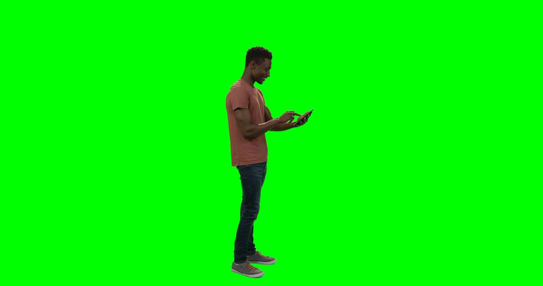 Man Engaging with Digital Tablet on Vibrant Green Background